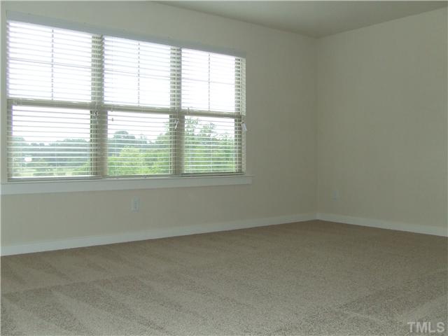 7803 Lillyhurst Drive Raleigh, NC 27612 - Photo 9 of 25 an empty room with a window