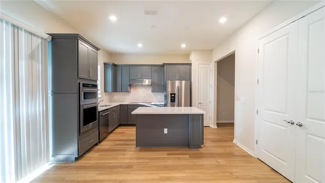 a kitchen with stainless steel appliances a refrigerator and a sink