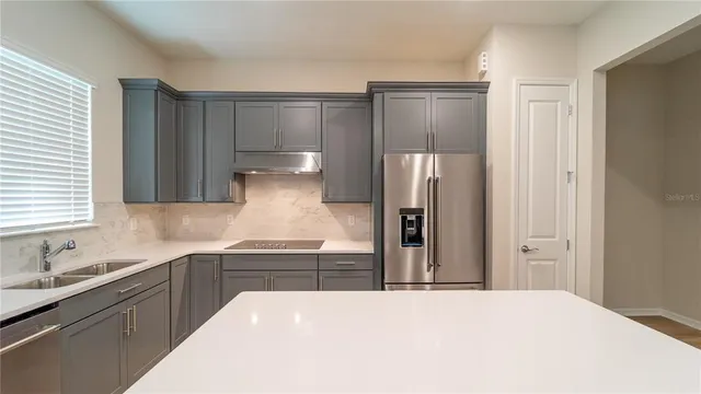 a kitchen with stainless steel appliances a refrigerator and a sink