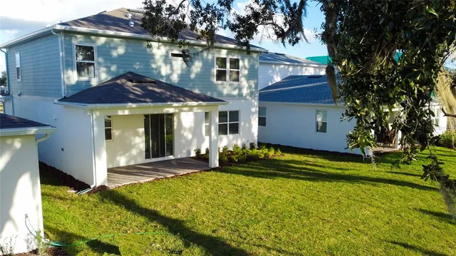 an aerial view of a house with backyard