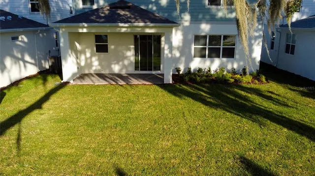 an aerial view of a house with a yard and outdoor seating