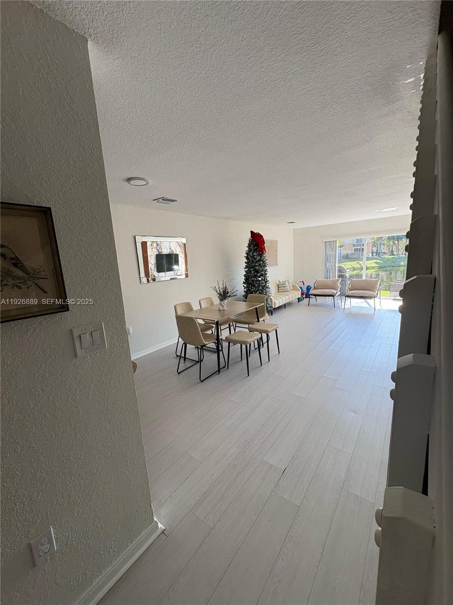 12842 Southwest 31st Street, Unit 134 Miramar, FL 33027 - Photo 11 of 30 a living room with furniture and a flat screen tv