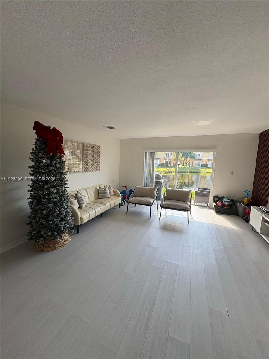 12842 Southwest 31st Street, Unit 134 Miramar, FL 33027 - Photo 12 of 30 a room with furniture and a large window