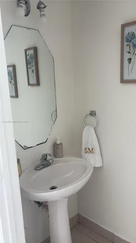 a bathroom with a sink and mirror