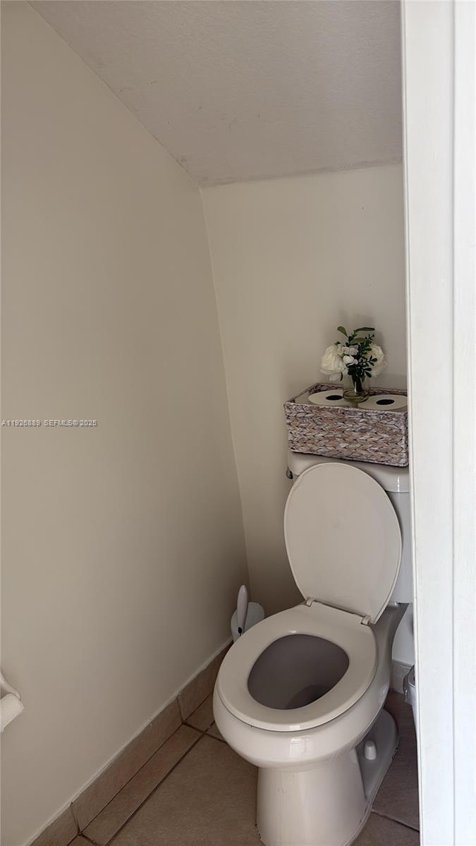 12842 Southwest 31st Street, Unit 134 Miramar, FL 33027 - Photo 16 of 30 a bathroom with a toilet and a sink