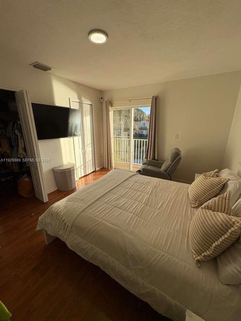 12842 Southwest 31st Street, Unit 134 Miramar, FL 33027 - Photo 17 of 30 a bedroom with a bed and a television