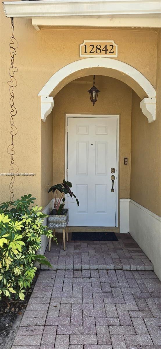 12842 Southwest 31st Street, Unit 134 Miramar, FL 33027 - Photo 2 of 30 a front view of a house with a window