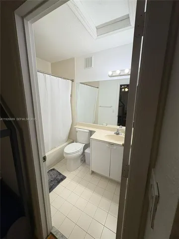 a bathroom with a sink a toilet a mirror and shower