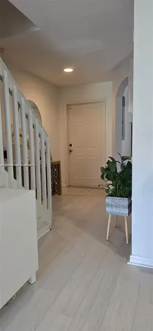 a view of an entryway with wooden floor
