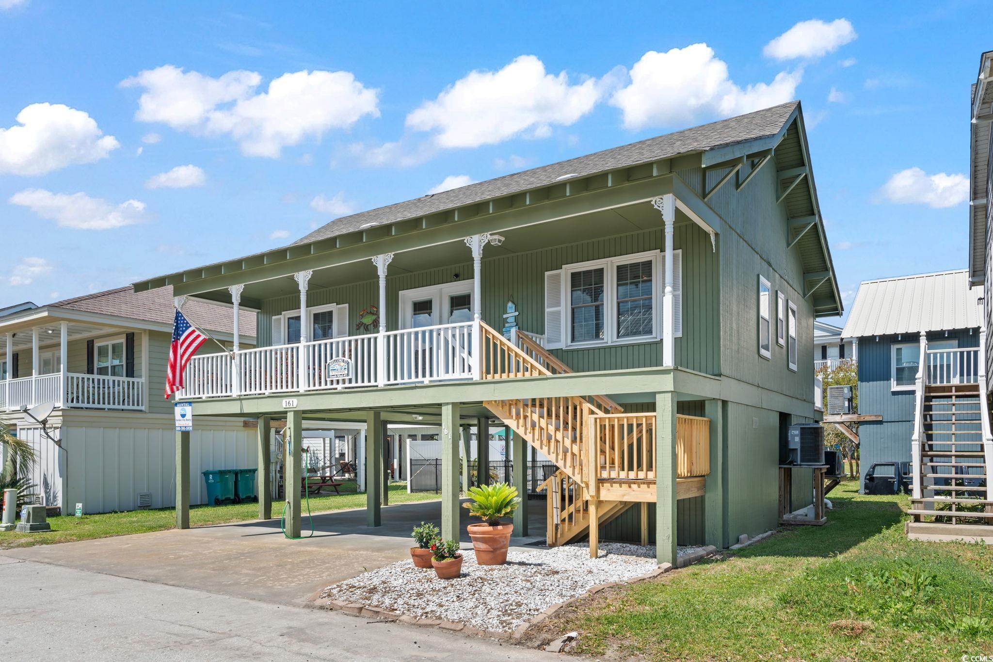 161 Easy Street Murrells Inlet, SC 29576 - Photo 1 of 40 View of front of home featuring stairs, concrete driveway, a carport, roof with shingles, and covered porch