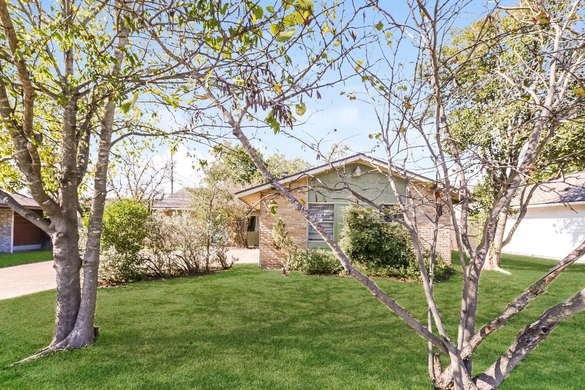 8116 Exmoor Drive, Unit B Austin, TX 78757 - Photo 1 of 15 a front view of a house with garden