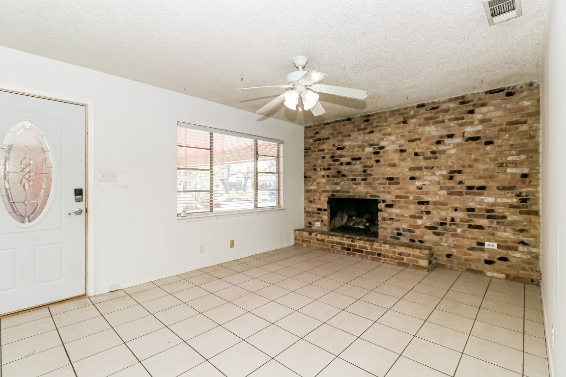 8116 Exmoor Drive, Unit B Austin, TX 78757 - Photo 4 of 15 a view of an empty room with a fireplace