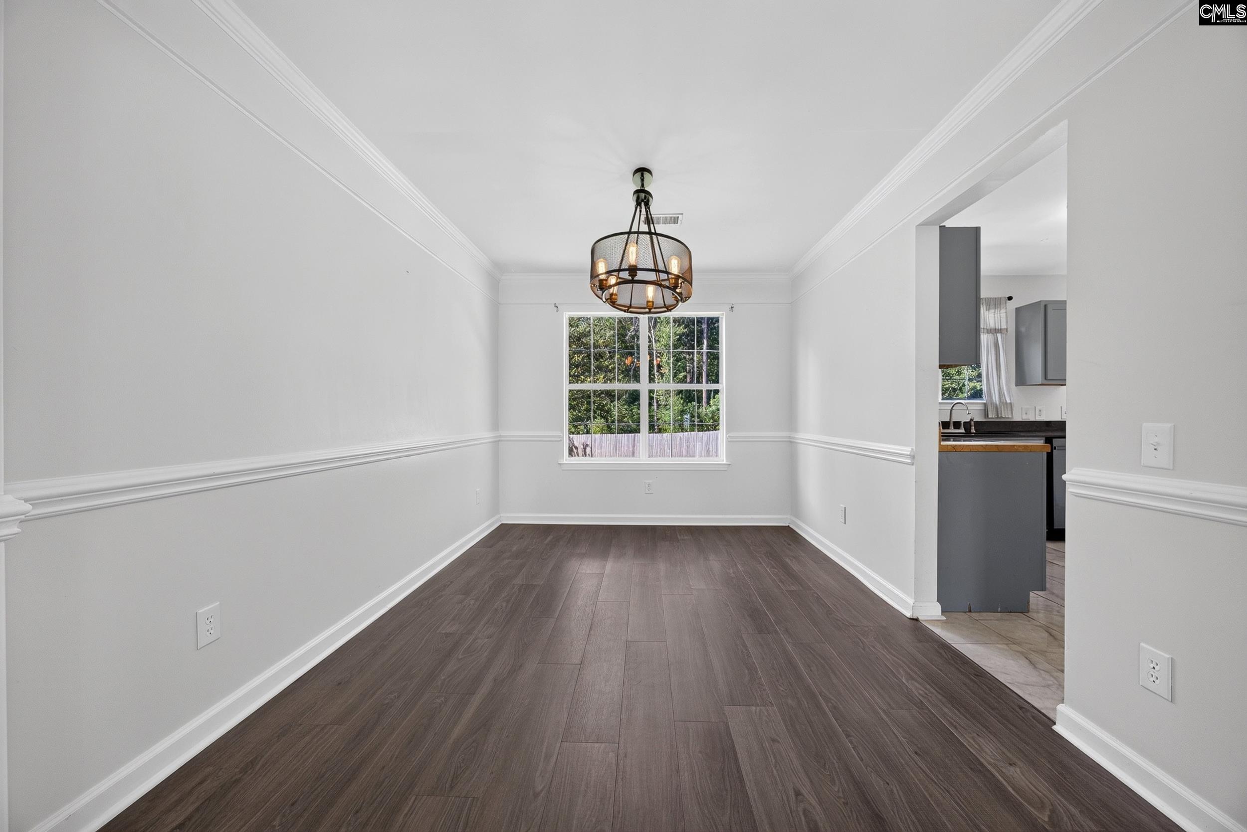 407 Sesqui Trail Columbia, SC 29223 - Photo 10 of 34 an empty room with wooden floor windows and cabinet