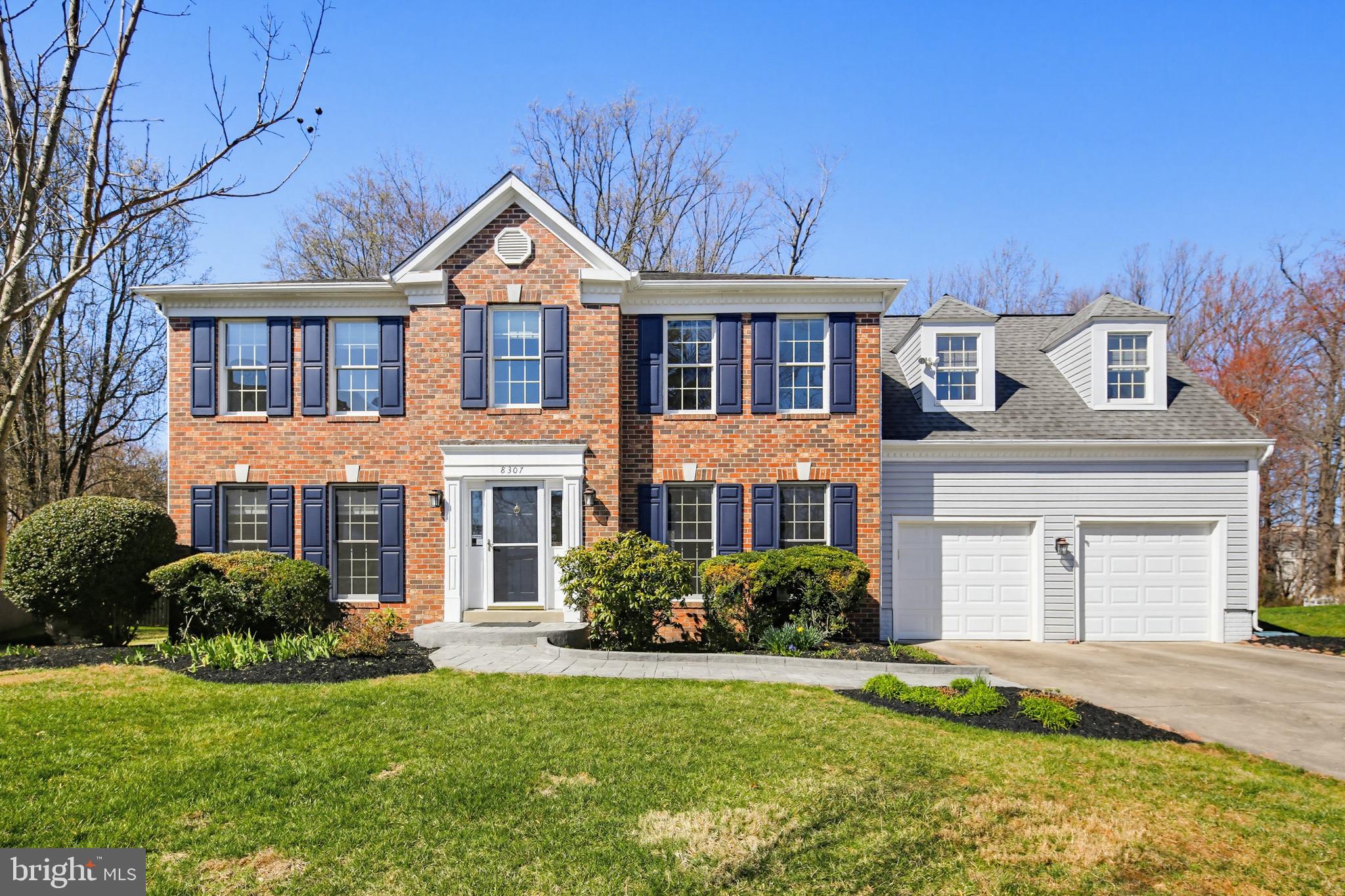 8307 Spring Blossom Court Laurel, MD 20723 - Photo 1 of 69 a front view of a house with a garden and plants