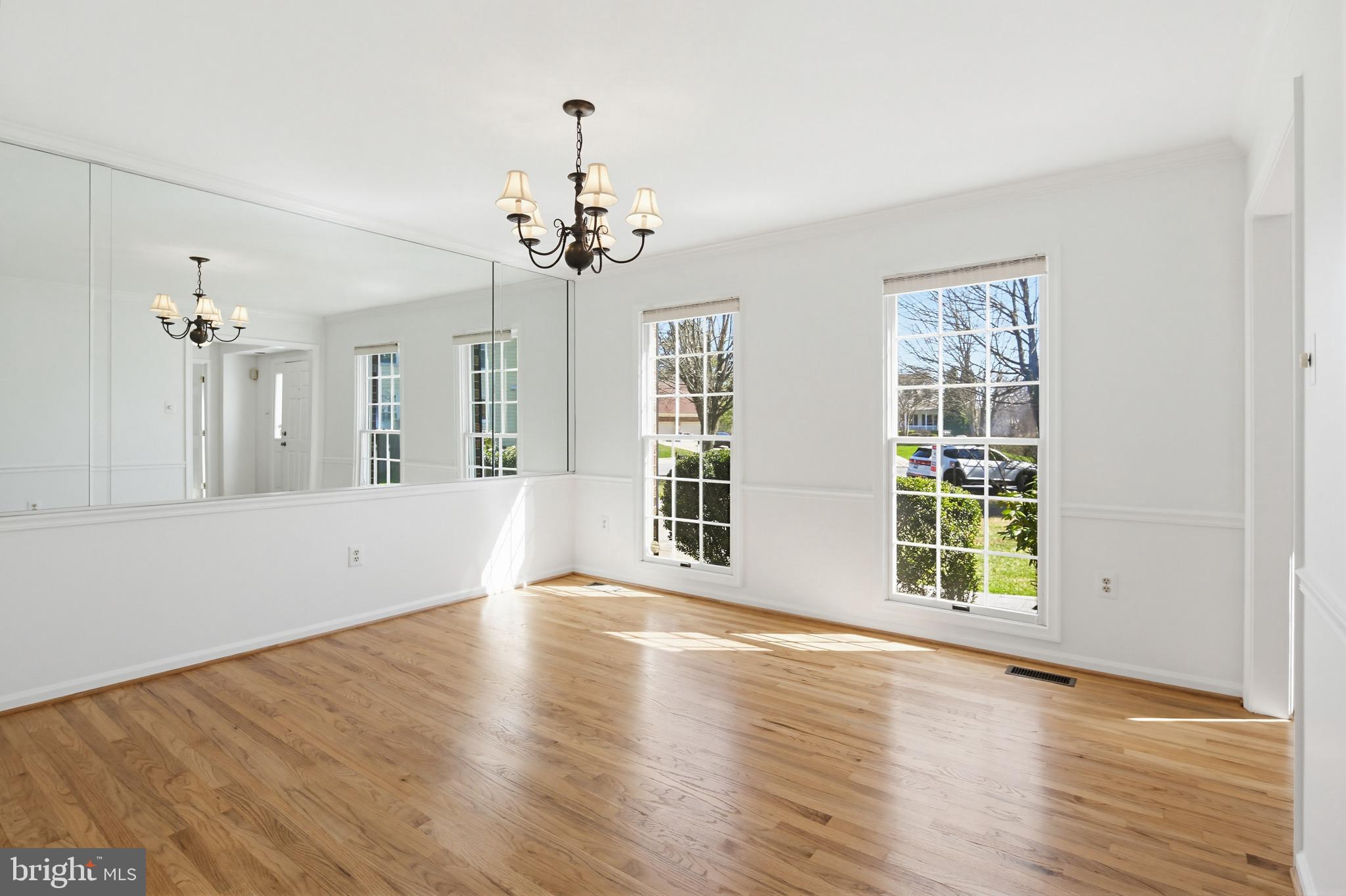 8307 Spring Blossom Court Laurel, MD 20723 - Photo 11 of 69 a view of an empty room with wooden floor and a window