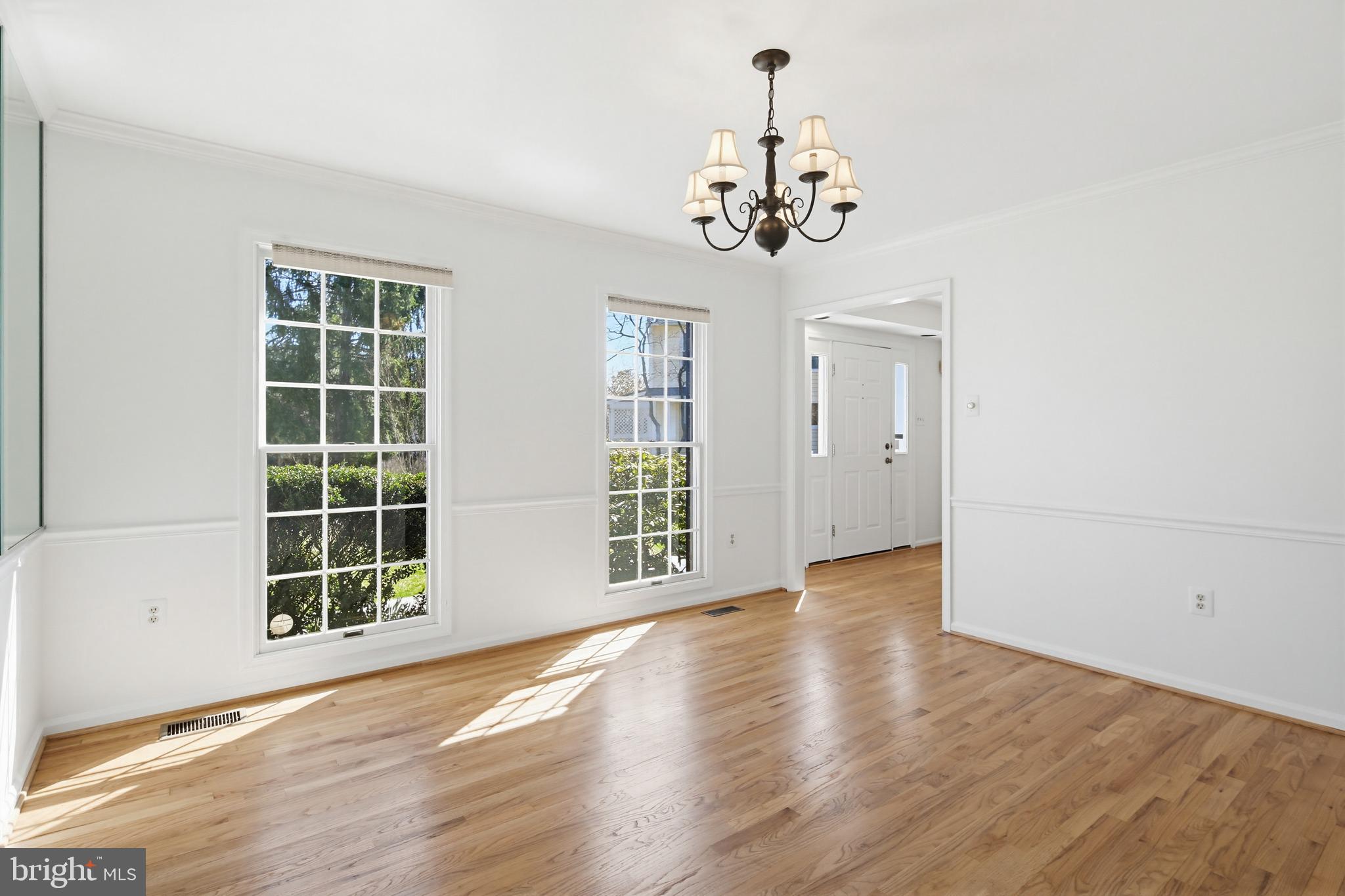 8307 Spring Blossom Court Laurel, MD 20723 - Photo 13 of 69 a view of an empty room with a window and wooden floor