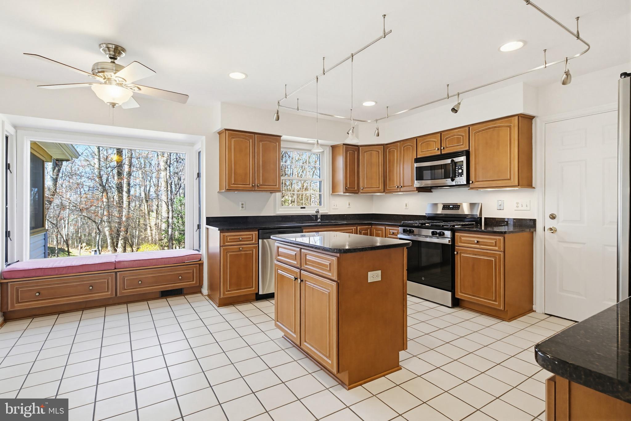 8307 Spring Blossom Court Laurel, MD 20723 - Photo 15 of 69 a kitchen with stainless steel appliances granite countertop a stove top oven a sink a counter top space and cabinets