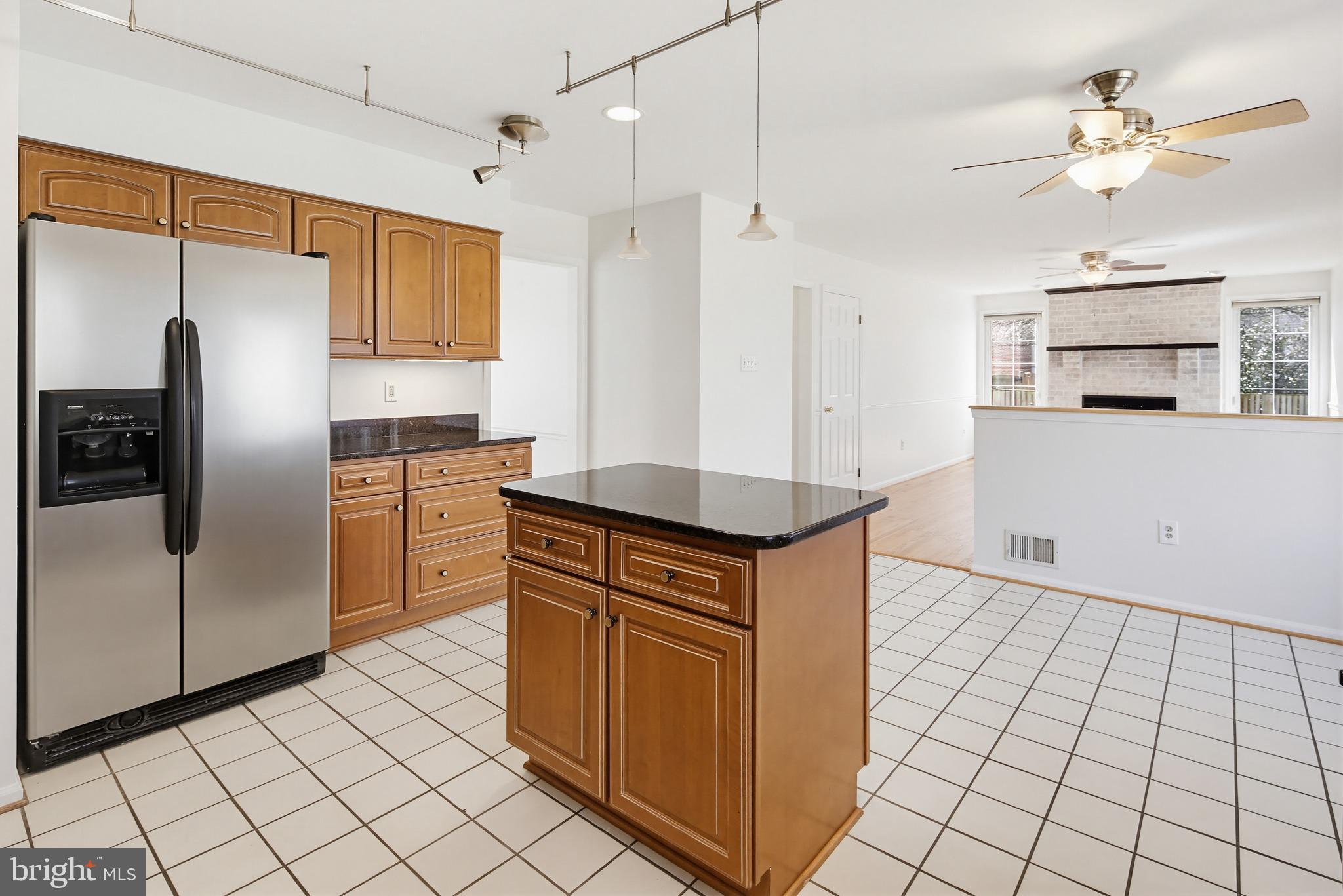 8307 Spring Blossom Court Laurel, MD 20723 - Photo 18 of 69 a kitchen with stainless steel appliances granite countertop a refrigerator a sink and white cabinets