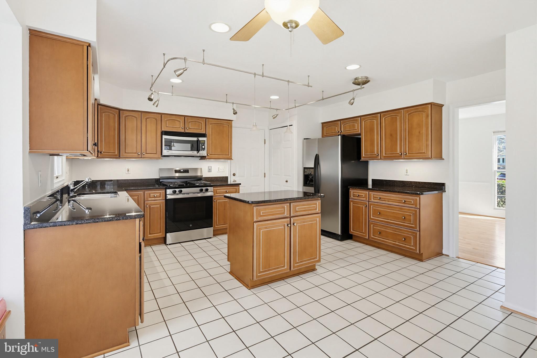 8307 Spring Blossom Court Laurel, MD 20723 - Photo 19 of 69 a kitchen with stainless steel appliances granite countertop a stove a sink and a refrigerator