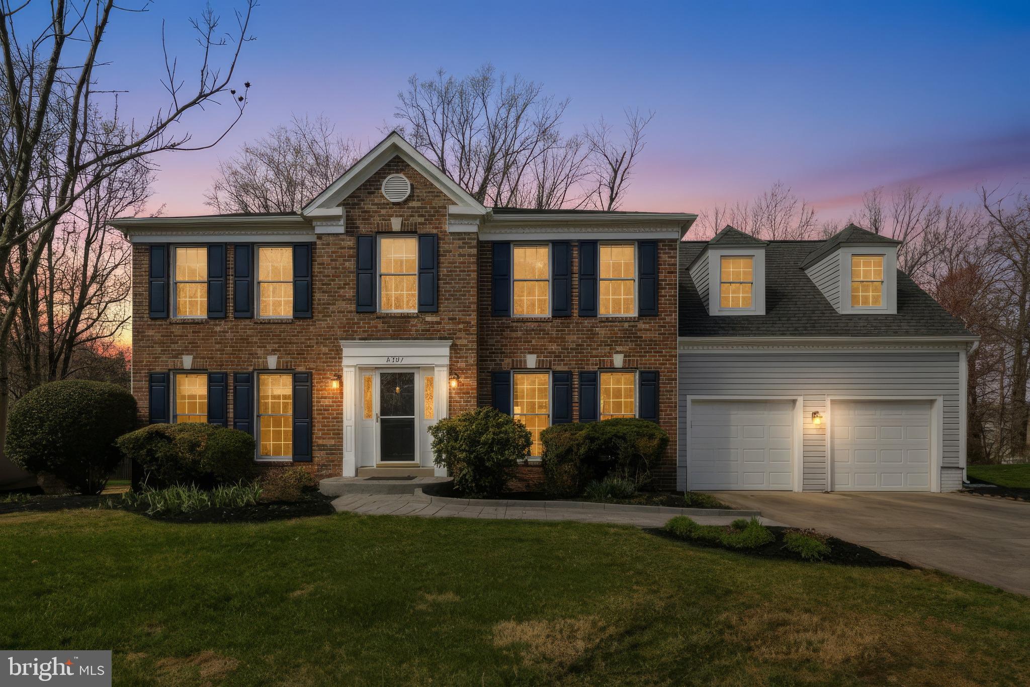 8307 Spring Blossom Court Laurel, MD 20723 - Photo 2 of 69 a front view of a house with a yard and garage