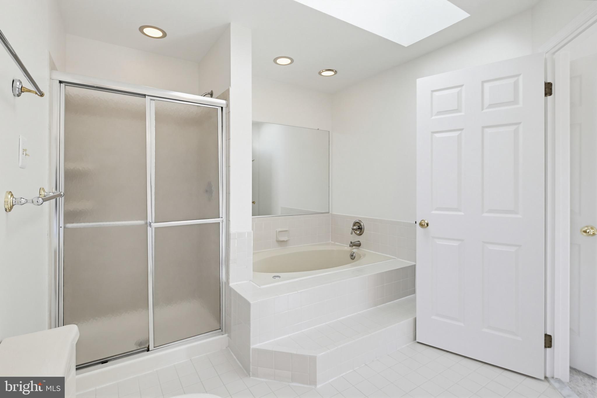 8307 Spring Blossom Court Laurel, MD 20723 - Photo 35 of 69 a bathroom with a bathtub and a shower