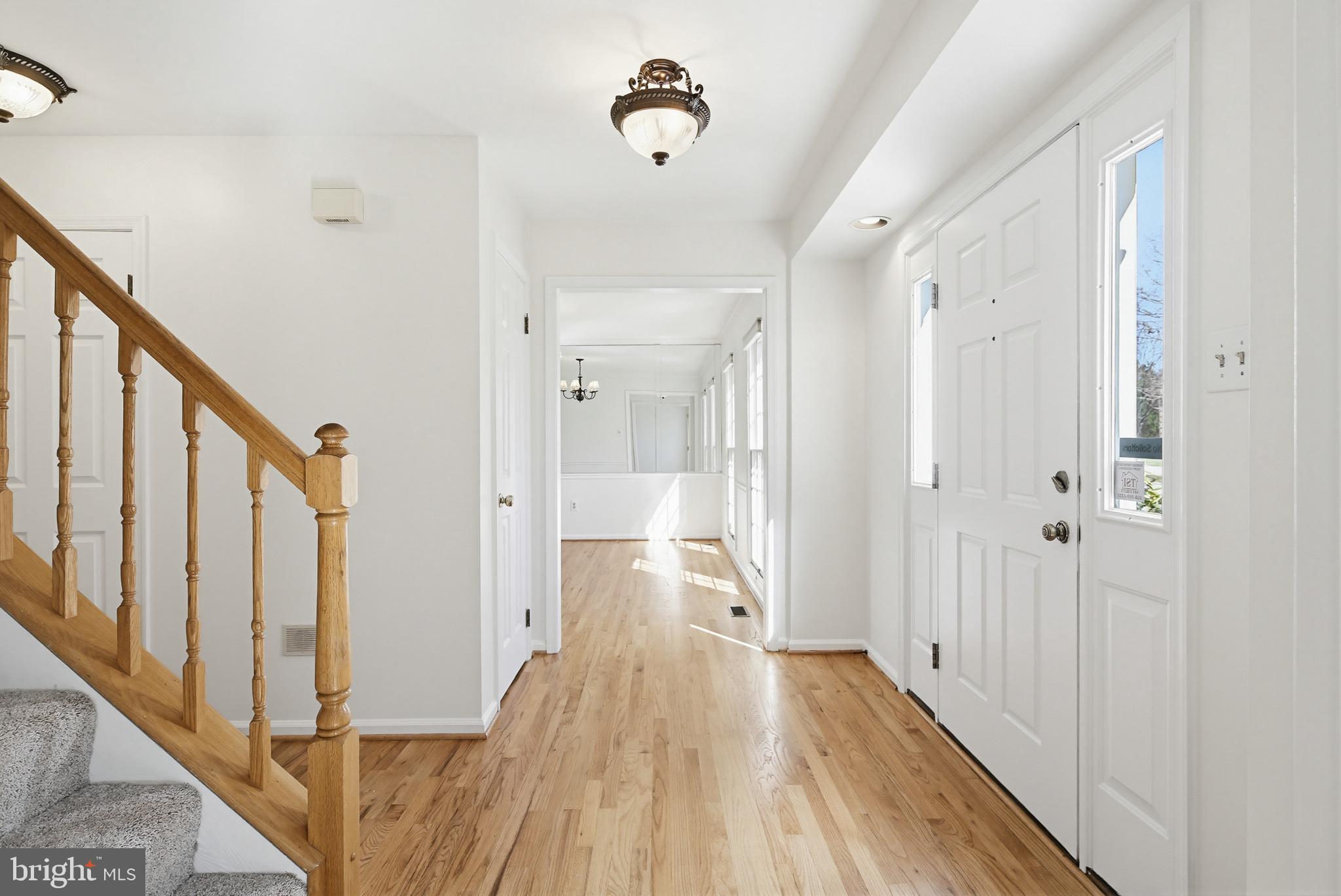 8307 Spring Blossom Court Laurel, MD 20723 - Photo 5 of 69 a view of a hallway with wooden floor and staircase
