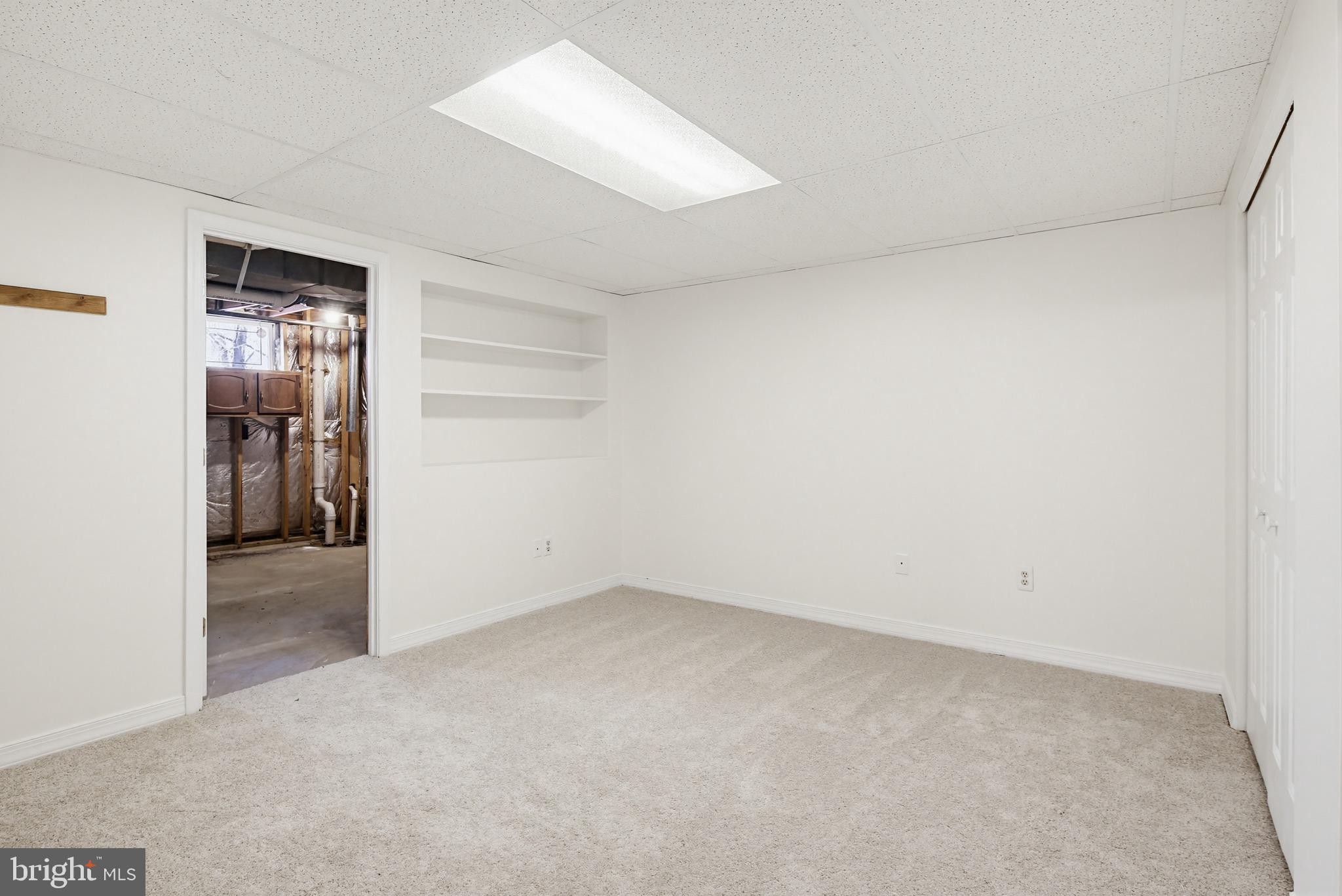 8307 Spring Blossom Court Laurel, MD 20723 - Photo 55 of 69 an empty room with closet and wooden door