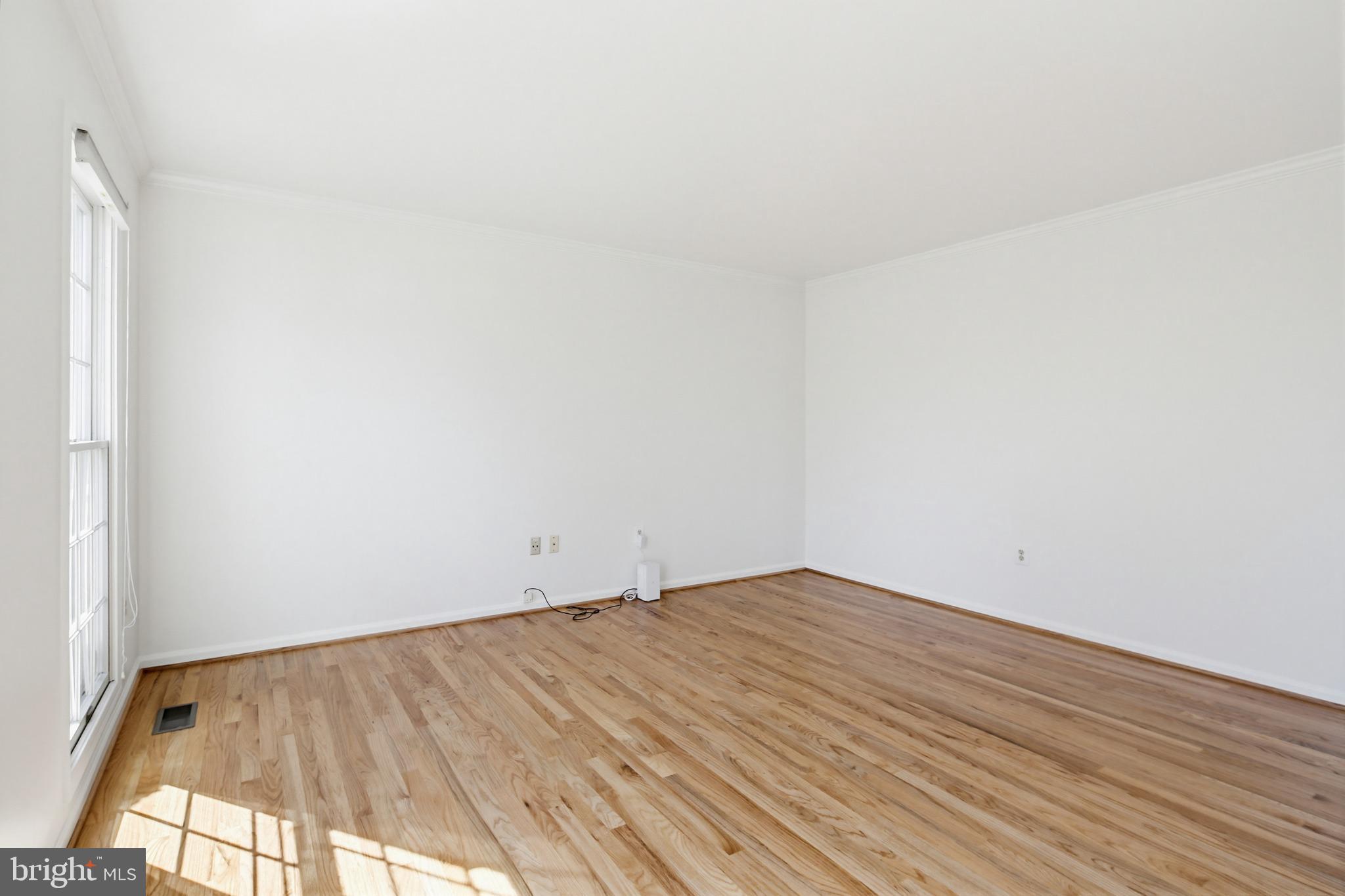8307 Spring Blossom Court Laurel, MD 20723 - Photo 8 of 69 a view of empty room with wooden floor and fan