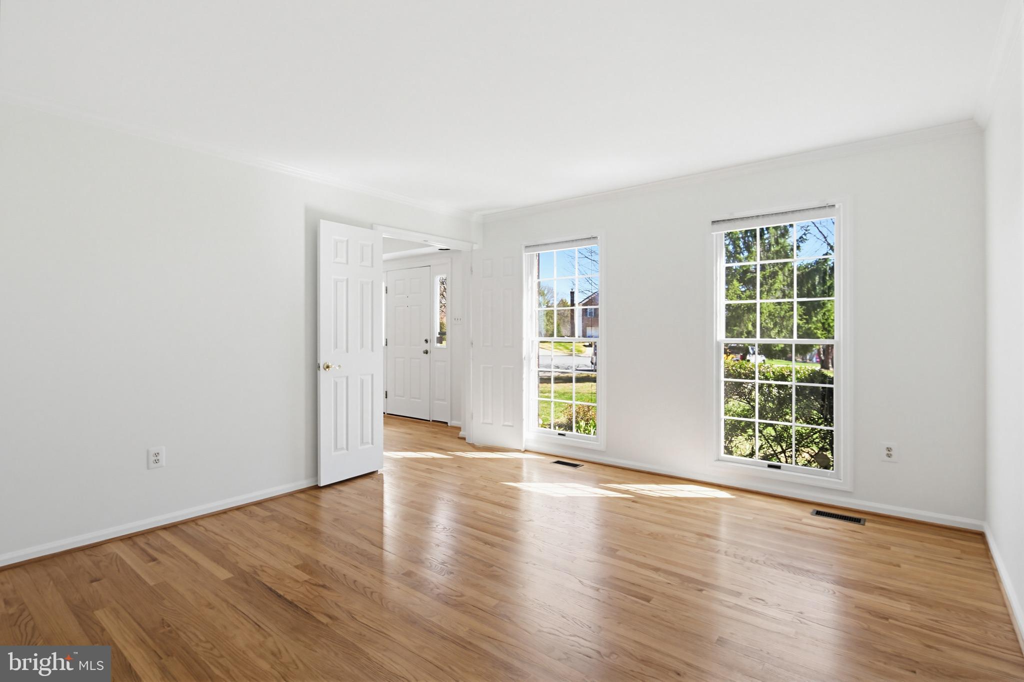 8307 Spring Blossom Court Laurel, MD 20723 - Photo 9 of 69 an empty room with wooden floor and windows