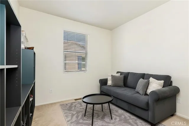 a living room with furniture and a hard wood floor