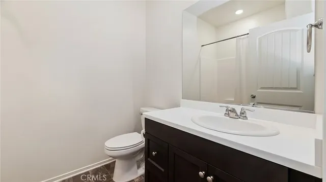 a bathroom with a sink a toilet and mirror