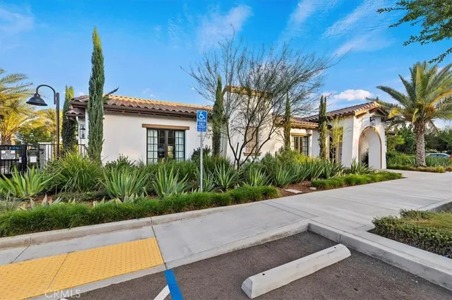 a view of a house with a yard and palm trees