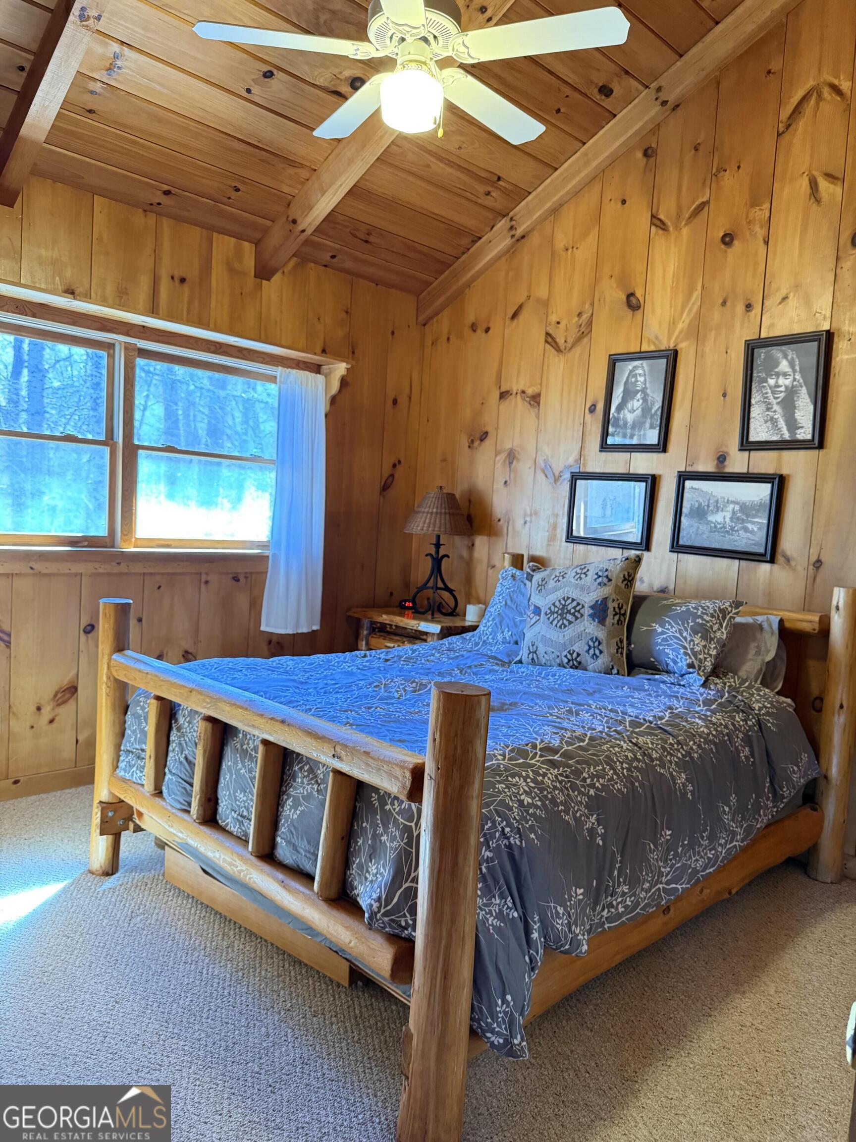 44 Cessna Lane Rabun Gap, GA 30568 - Photo 11 of 27 a bed sitting in a bedroom next to a window