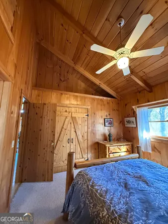 a bed sitting in a bedroom next to a window