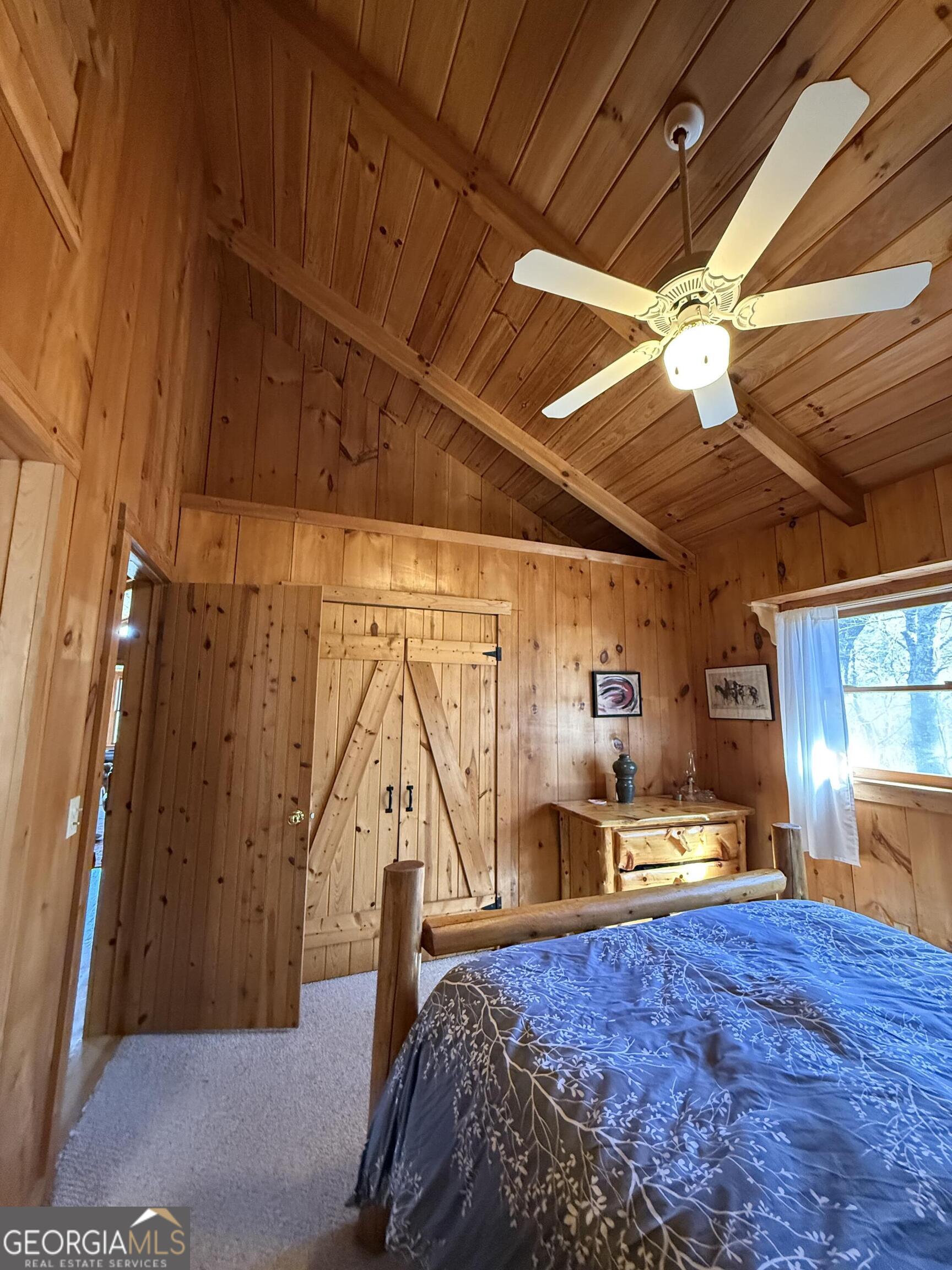 44 Cessna Lane Rabun Gap, GA 30568 - Photo 12 of 27 a bed sitting in a bedroom next to a window