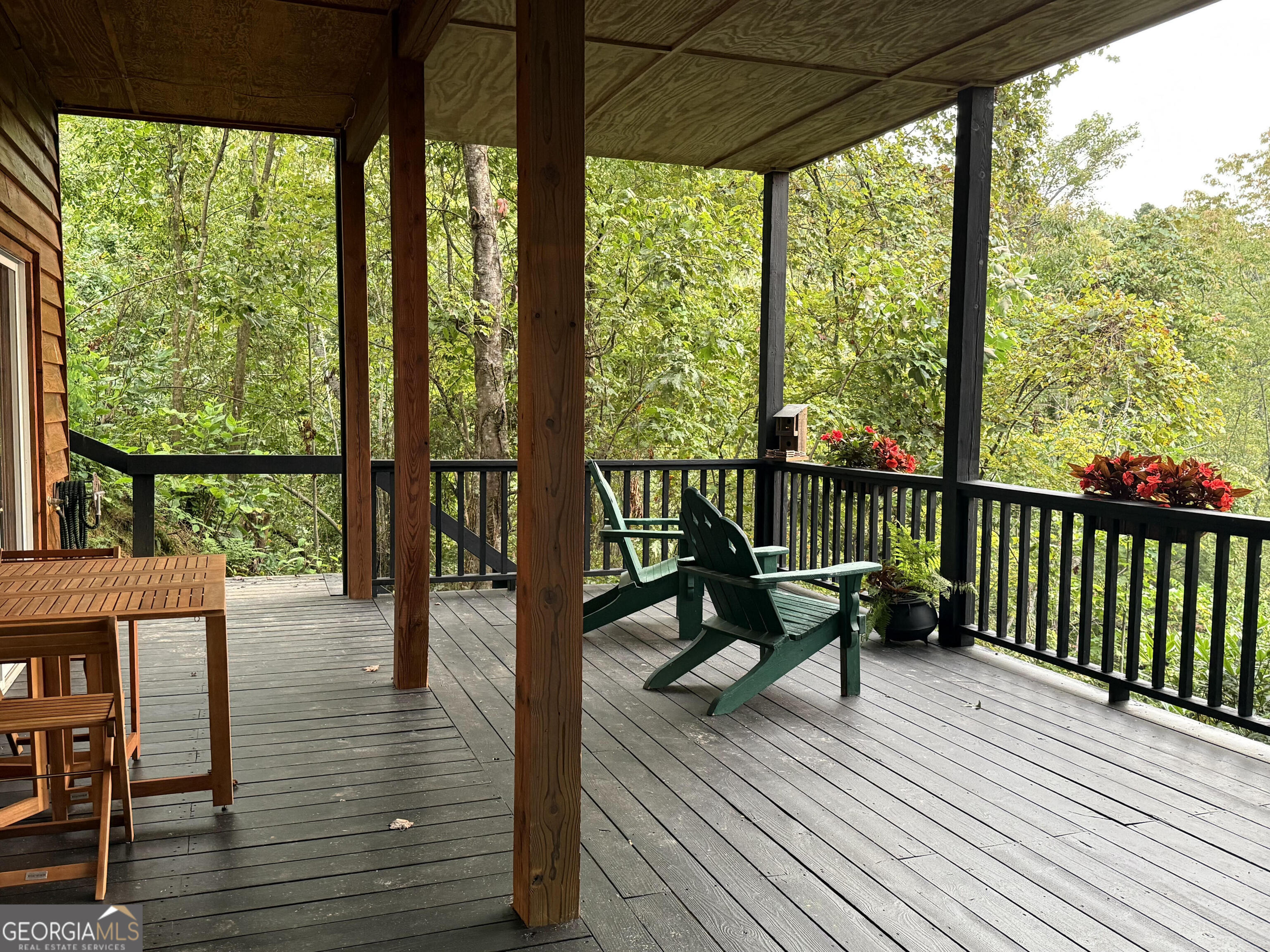 44 Cessna Lane Rabun Gap, GA 30568 - Photo 19 of 27 a view of balcony with chairs and wooden floor