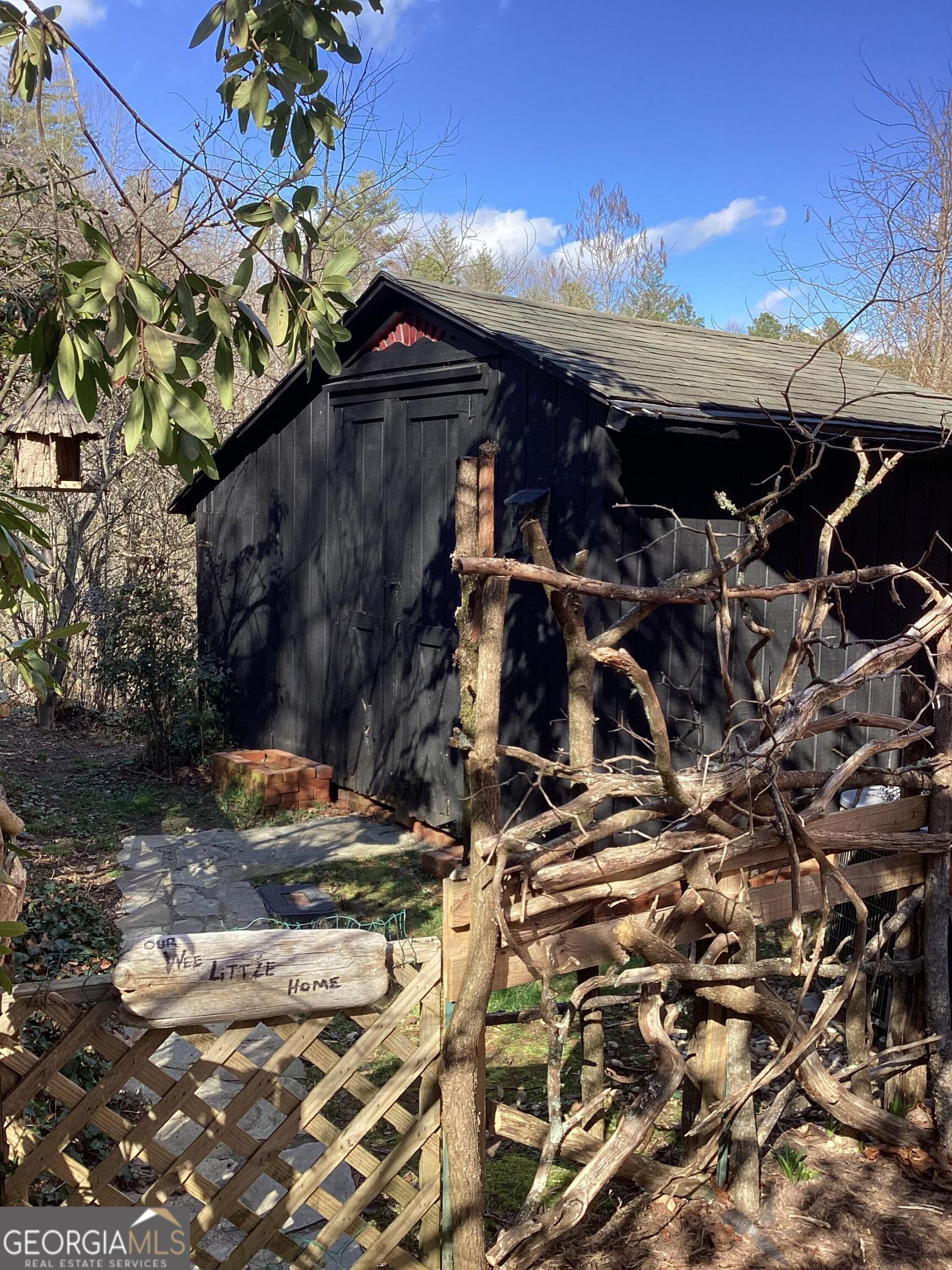 44 Cessna Lane Rabun Gap, GA 30568 - Photo 22 of 27 a view of a patio with table and chairs under an umbrella