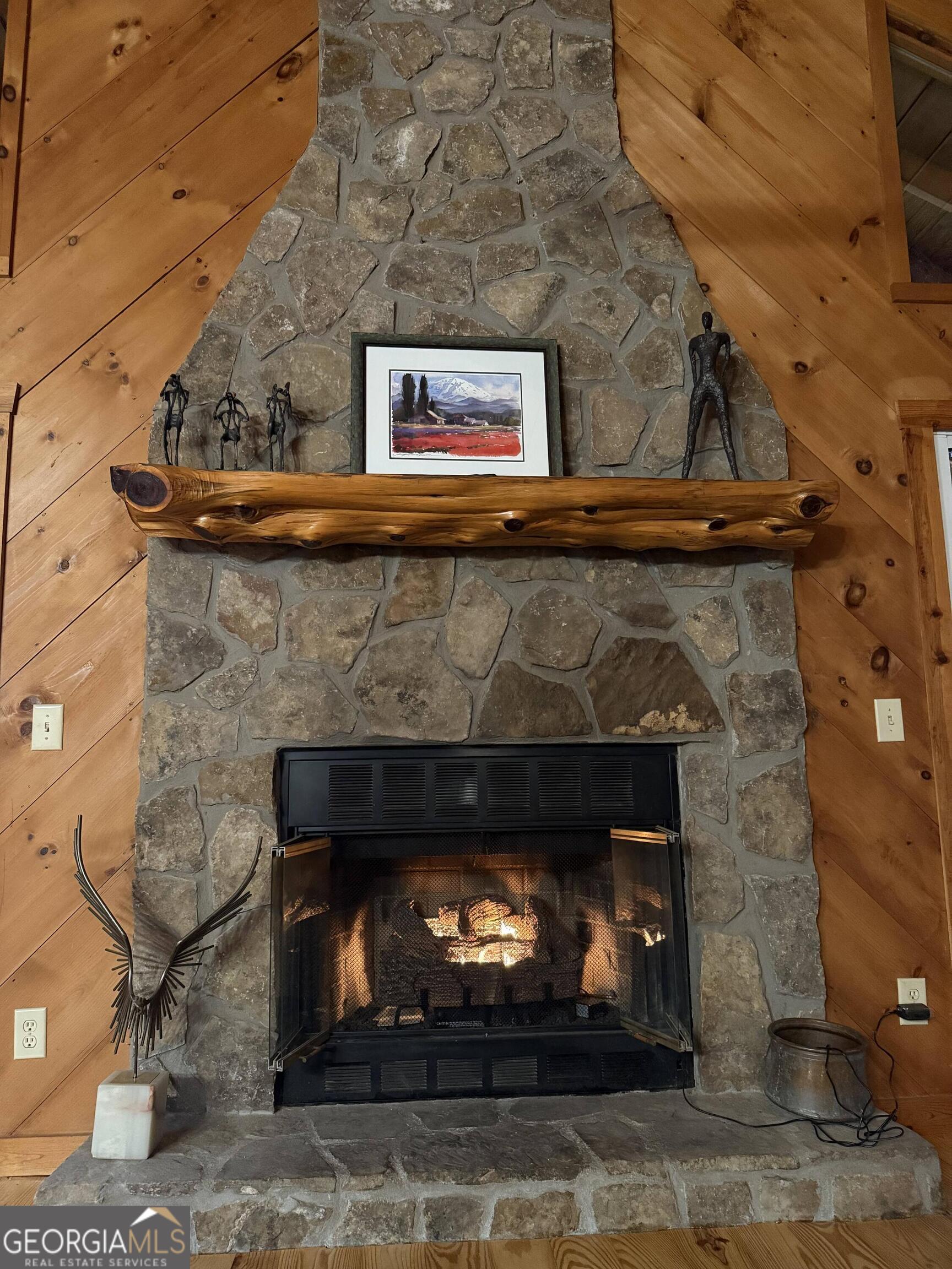 44 Cessna Lane Rabun Gap, GA 30568 - Photo 8 of 27 a fireplace with a clock on top of it