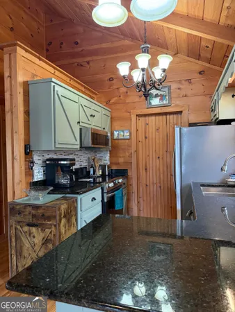 a kitchen with stove and cabinets