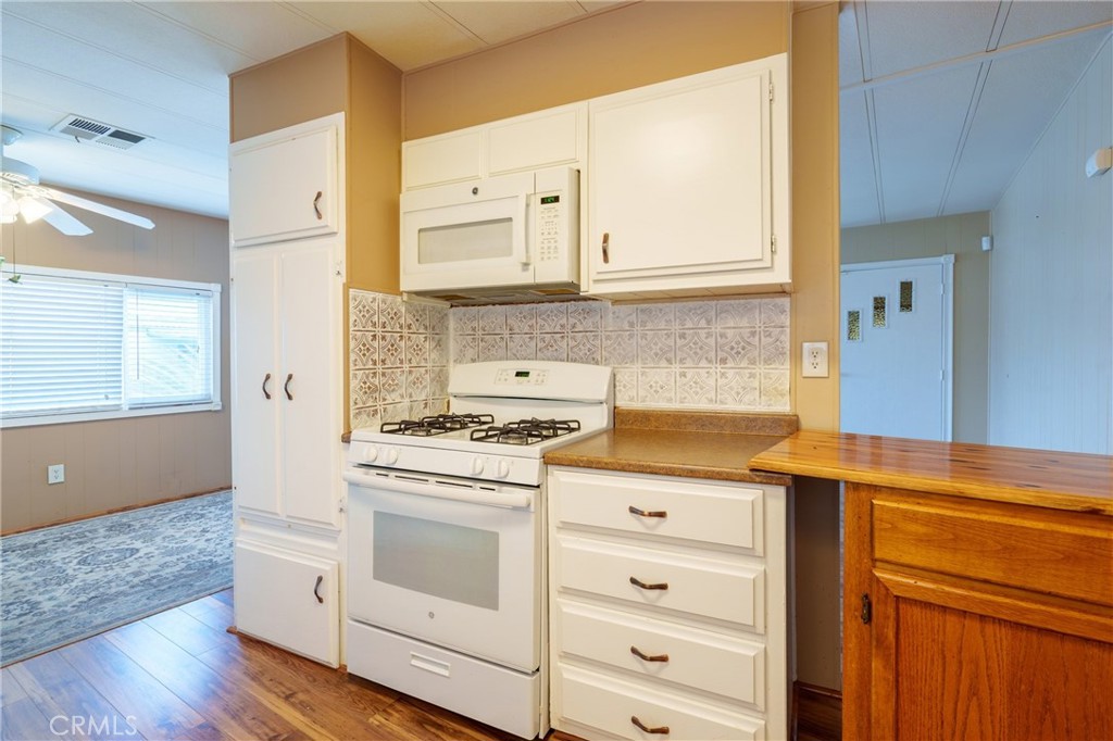 4000 Pierce Street, Unit 72 Riverside, CA 92505 - Photo 5 of 20 a kitchen with granite countertop white cabinets and white appliances