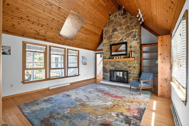 a view of a livingroom with wooden floor and furniture