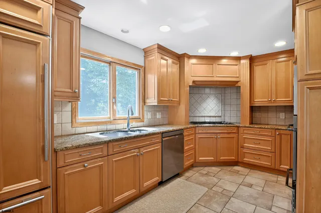 a kitchen with stainless steel appliances granite countertop a sink stove and cabinets