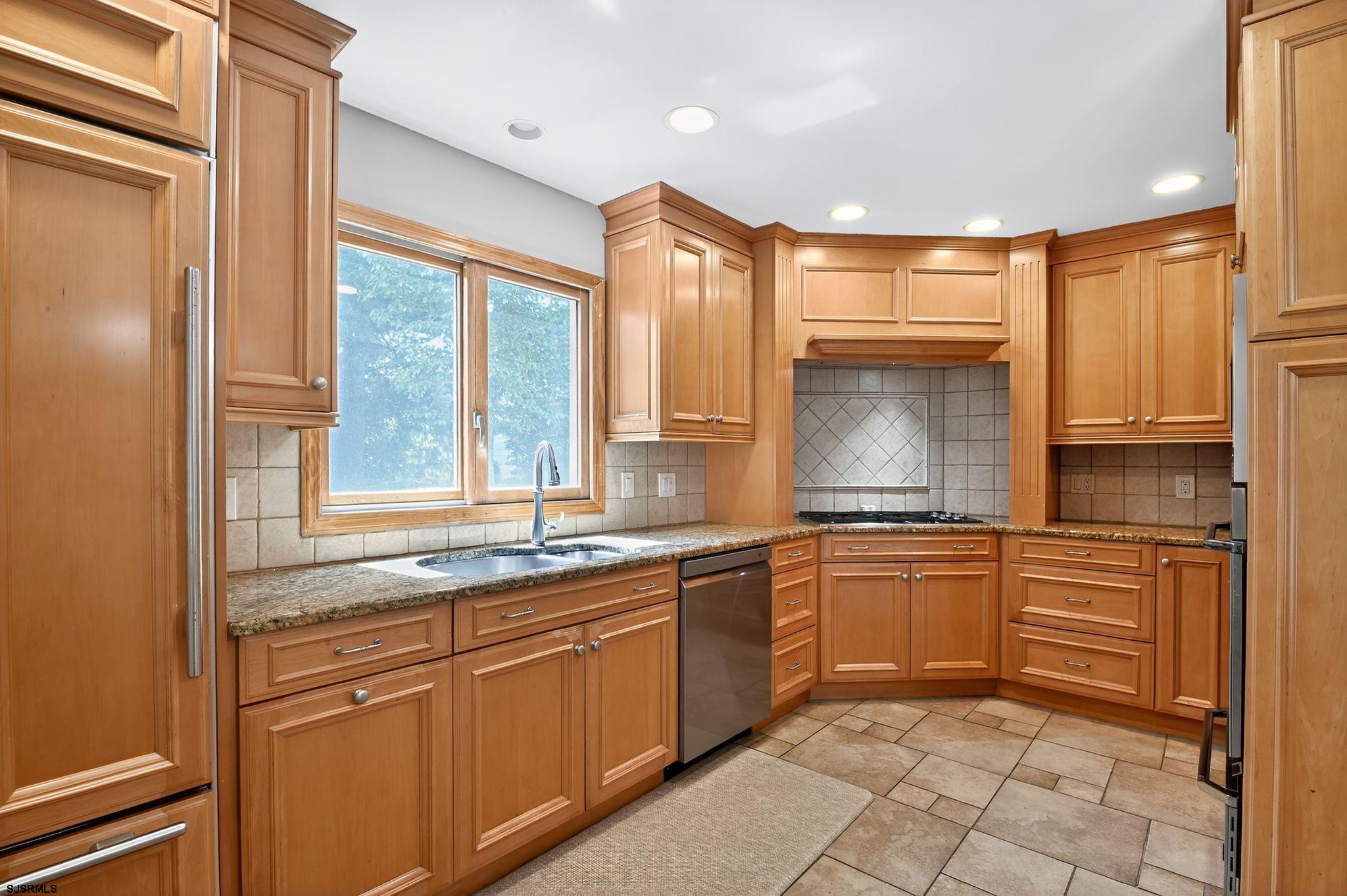 404 Cedarbrook Lane Linwood, NJ 08221 - Photo 15 of 33 a kitchen with granite countertop sink window and cabinets