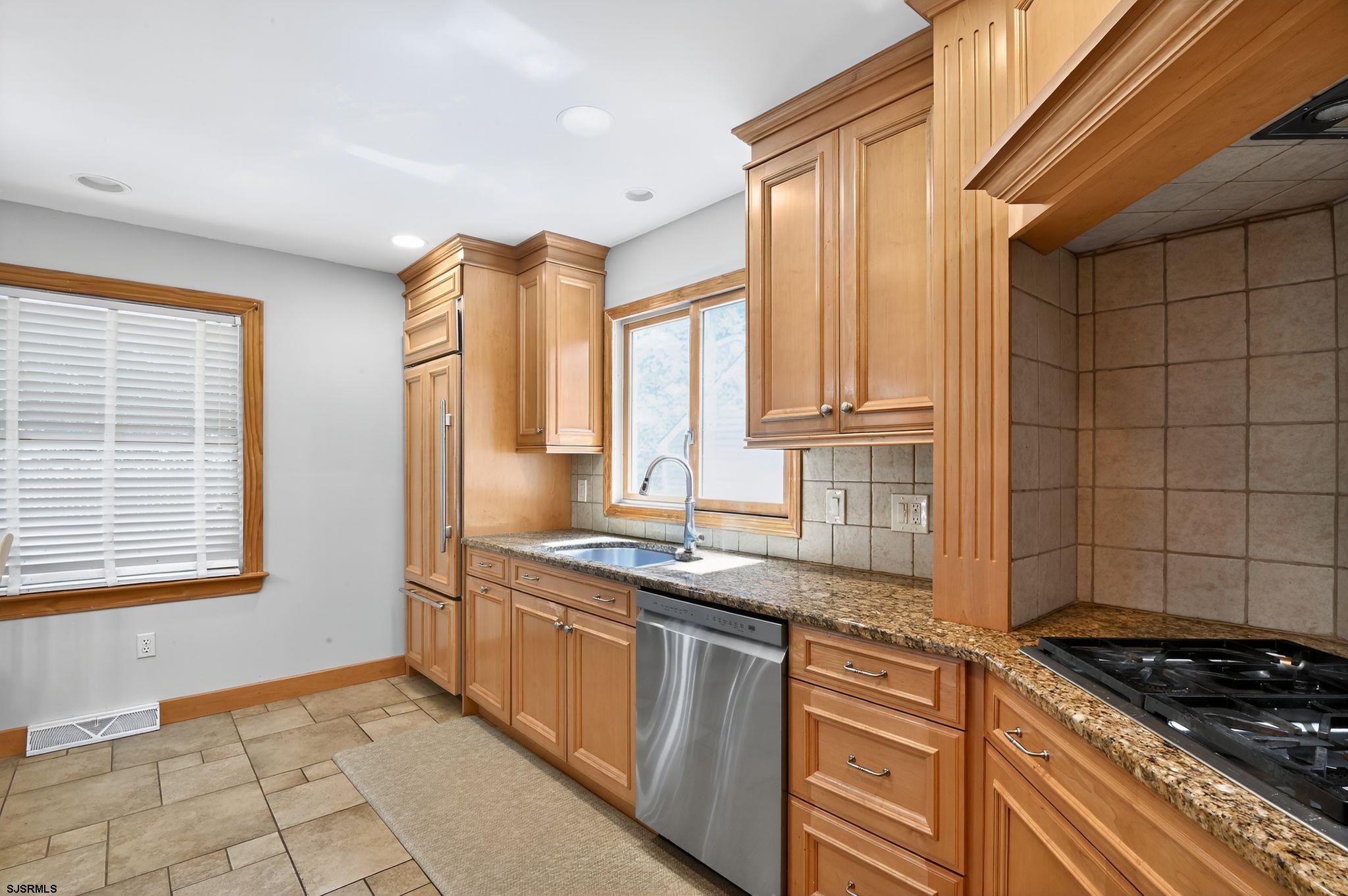 404 Cedarbrook Lane Linwood, NJ 08221 - Photo 16 of 33 a kitchen with stainless steel appliances granite countertop a sink stove and cabinets