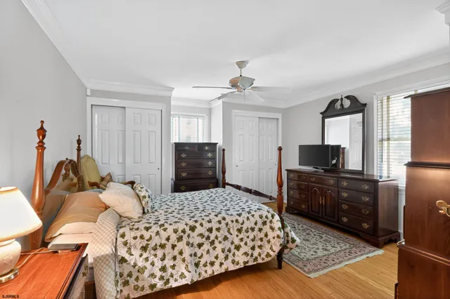 a bedroom with a bed a dresser and chair
