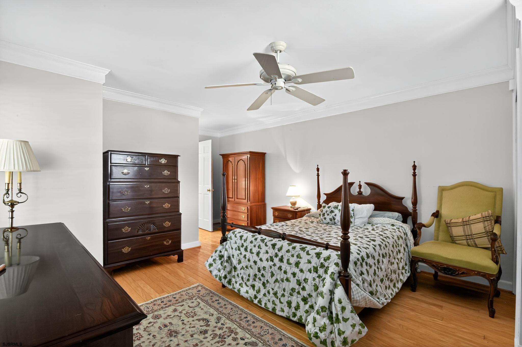 404 Cedarbrook Lane Linwood, NJ 08221 - Photo 21 of 33 a bedroom with a bed a dresser and chair