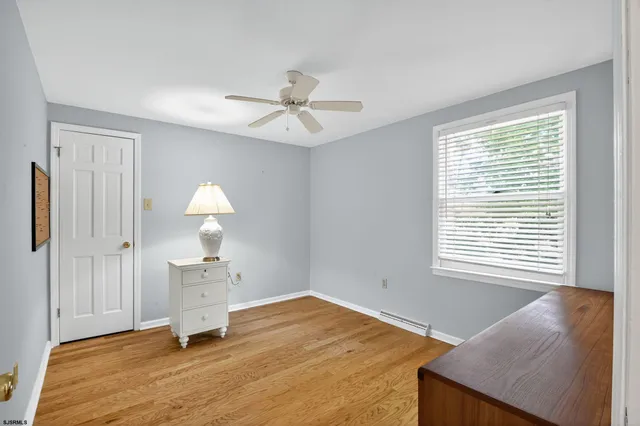 a bathroom with a granite countertop toilet sink and mirror