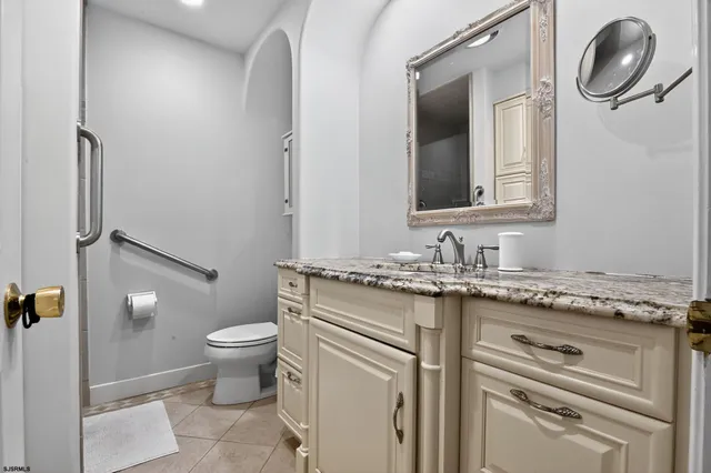 a bathroom with a sink toilet and mirror
