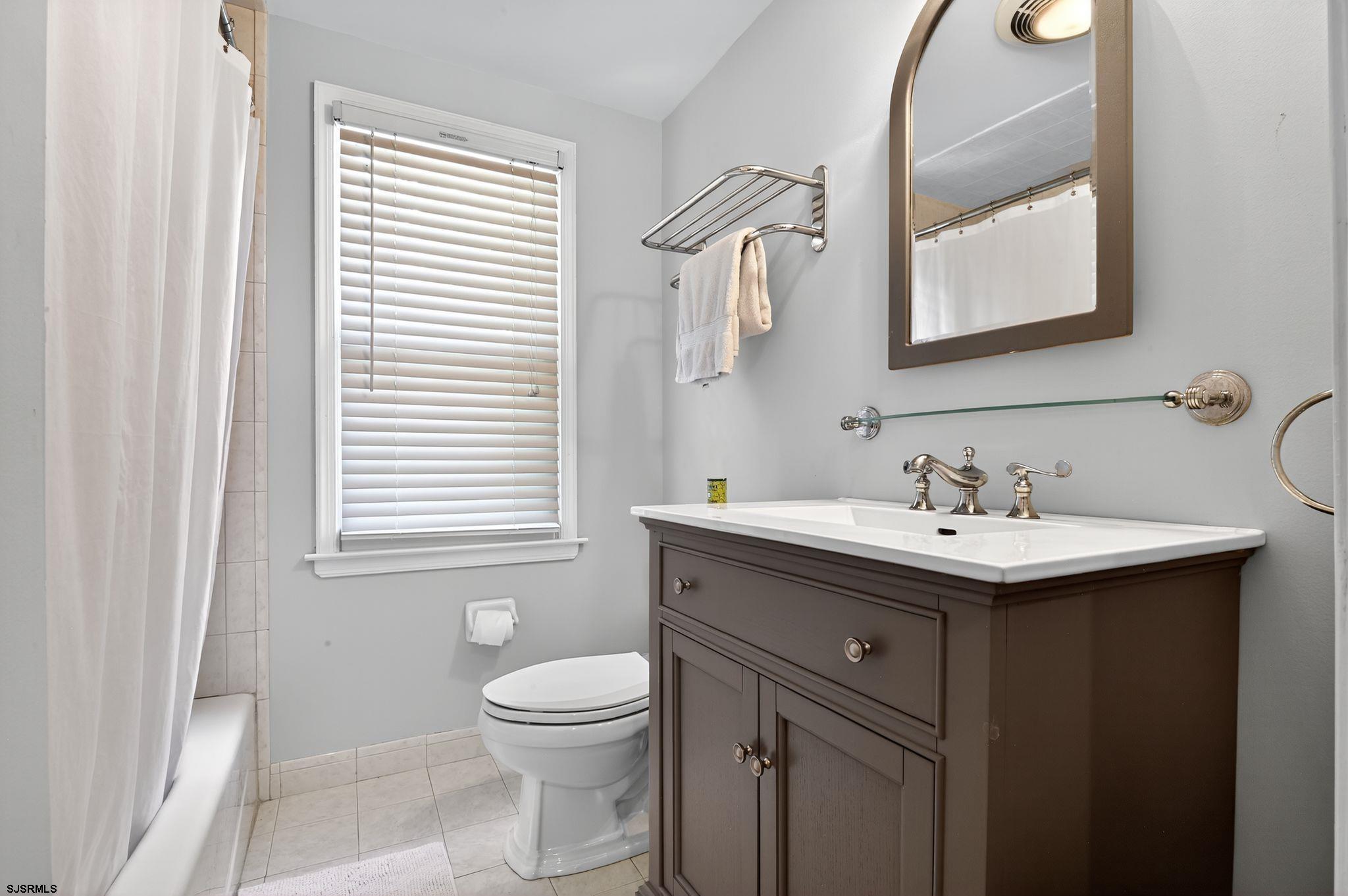 404 Cedarbrook Lane Linwood, NJ 08221 - Photo 26 of 33 a bathroom with a sink toilet and mirror