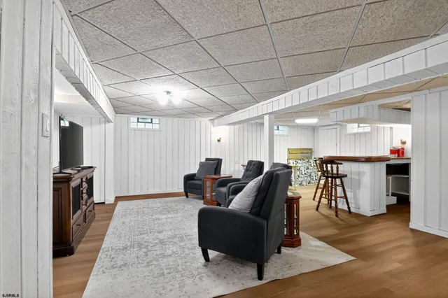 a dining room with furniture and a floor to ceiling window